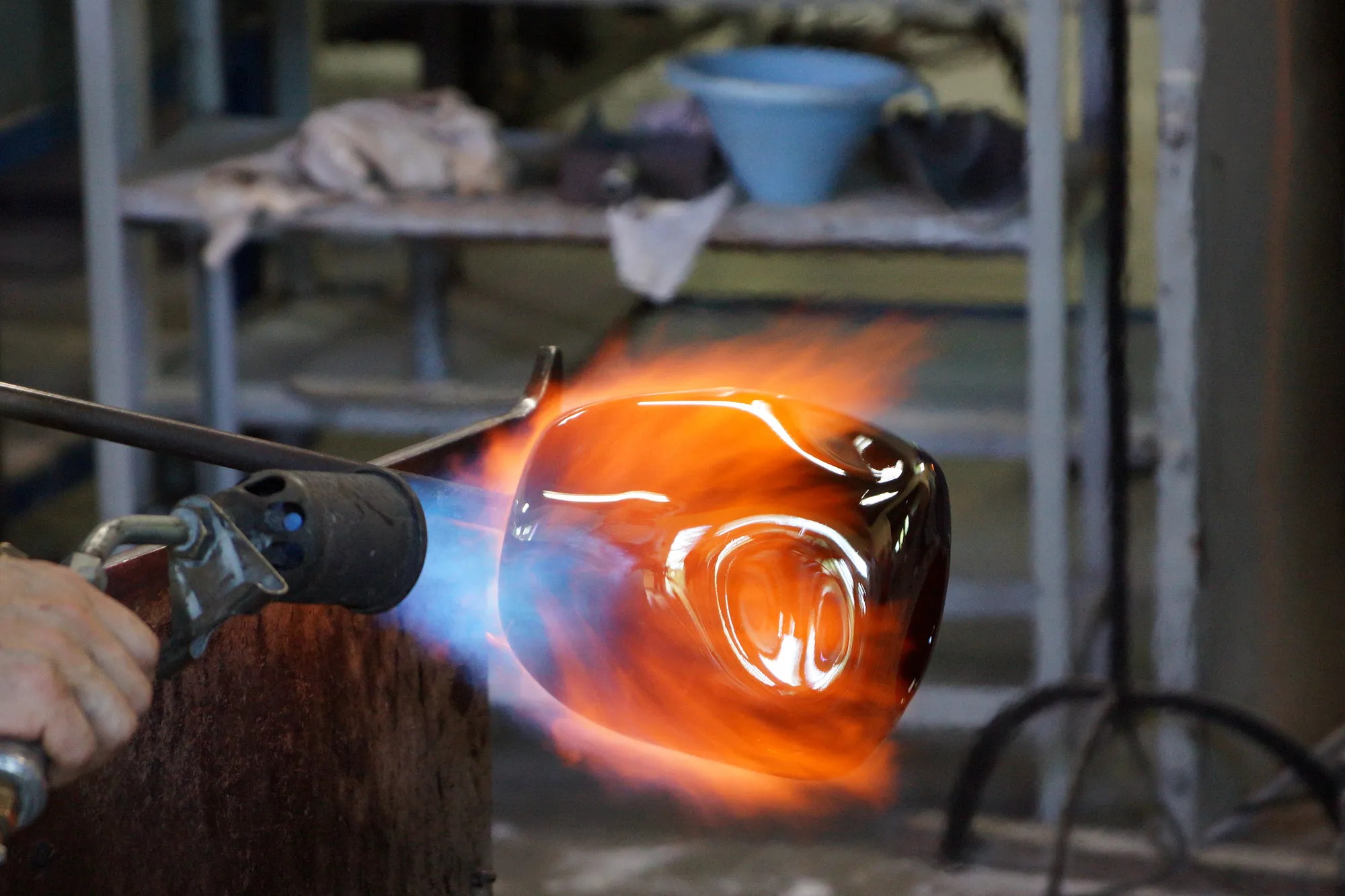 A torch putting fire on a piece of glass